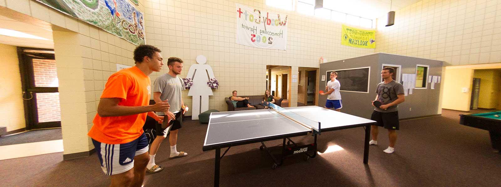 students playing ping-pong in dorm lobby